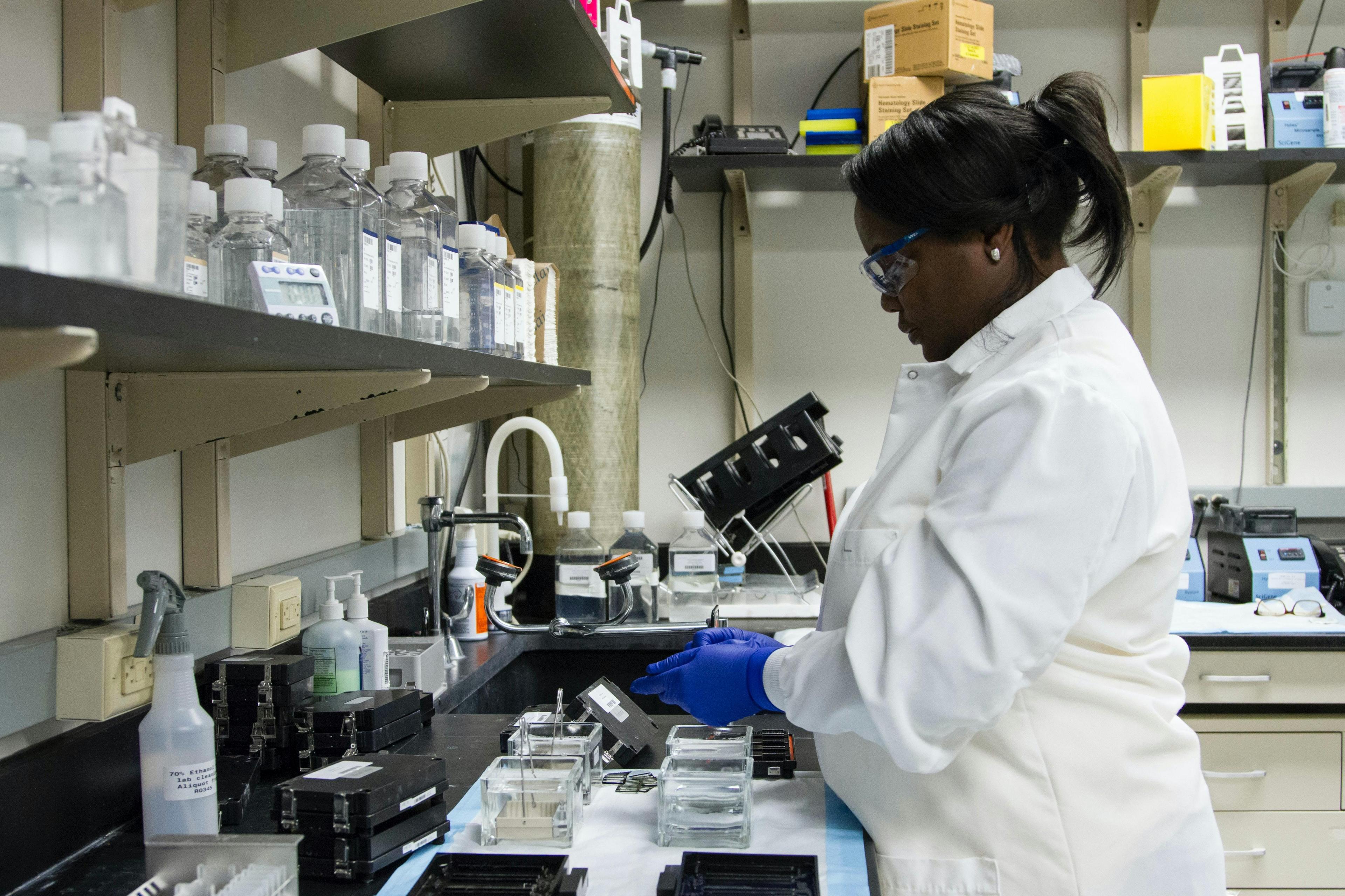 researcher wearing blue gloves