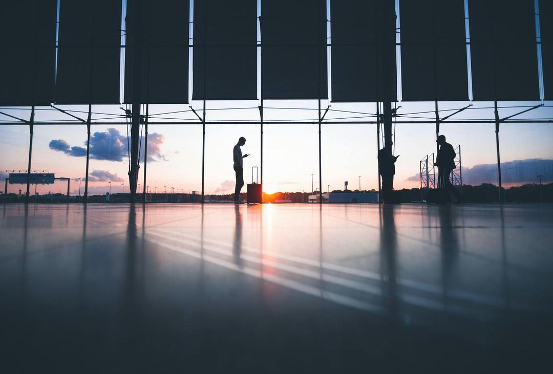 sunset photo of a guy with a luggage