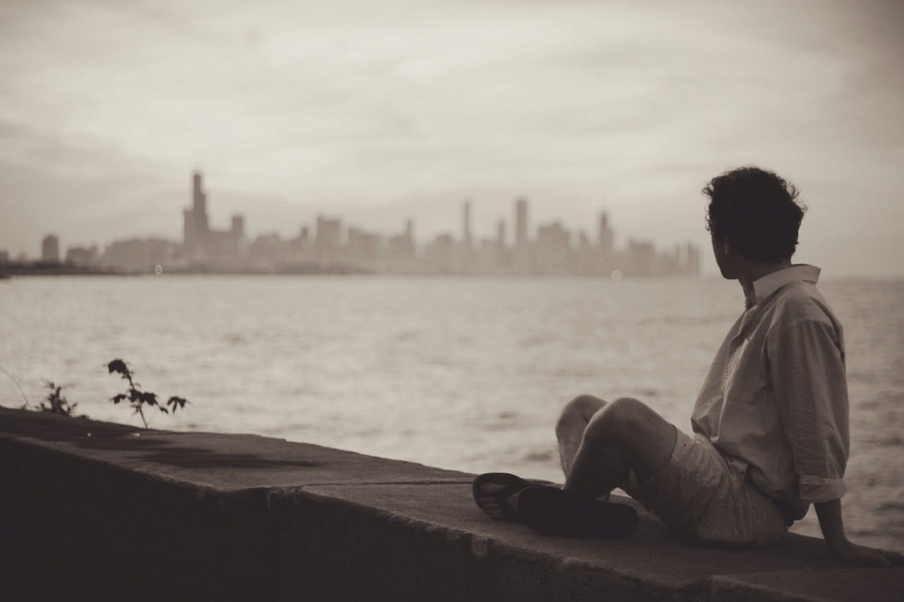 man staring at the ocean