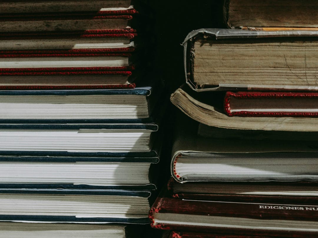 Two stacks of textbooks: one old and one new.