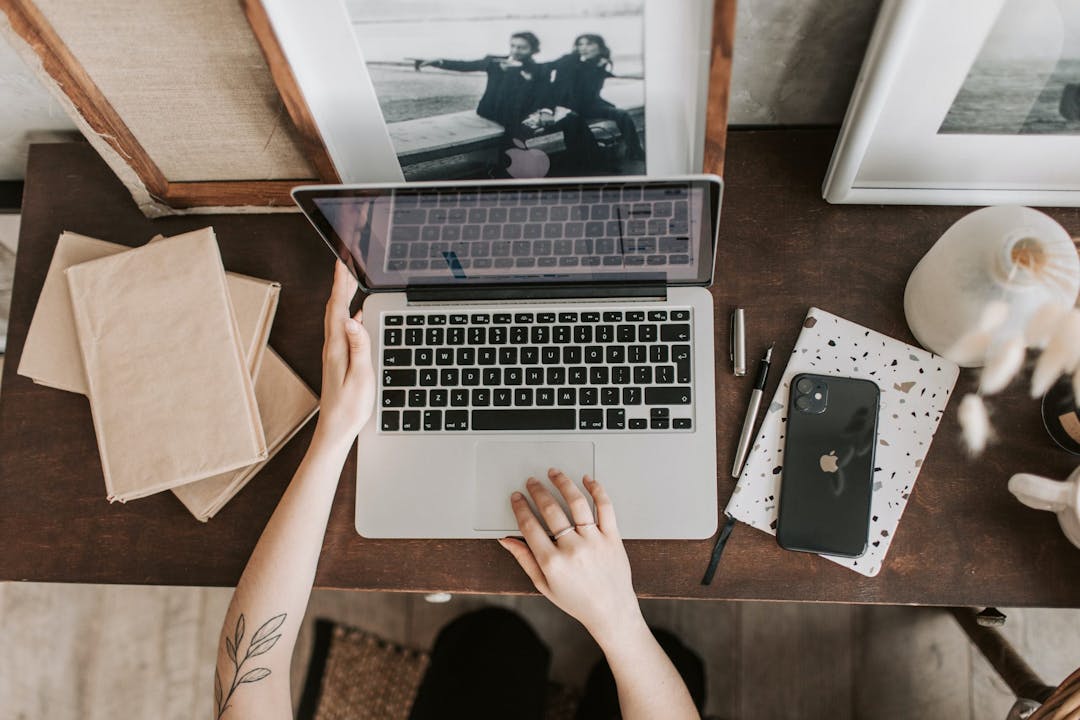 working on a laptop with tattoo