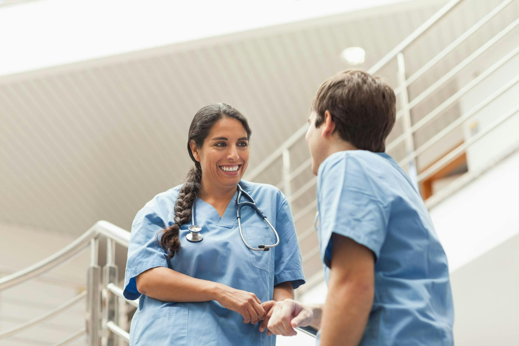 Nurses talking on stairs in hospital